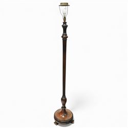 20th century mahogany standard lamp, with fluted tapering column above a turned and moulde...