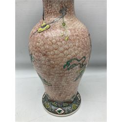 Pair of early 20th century chinese vases of baluster form with with trumpet neck, decorated with vase display upon a red whorl ground, H36cm 