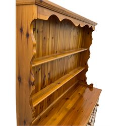Pine farmhouse dresser with three drawers and three cupboards, and two tier plate rack