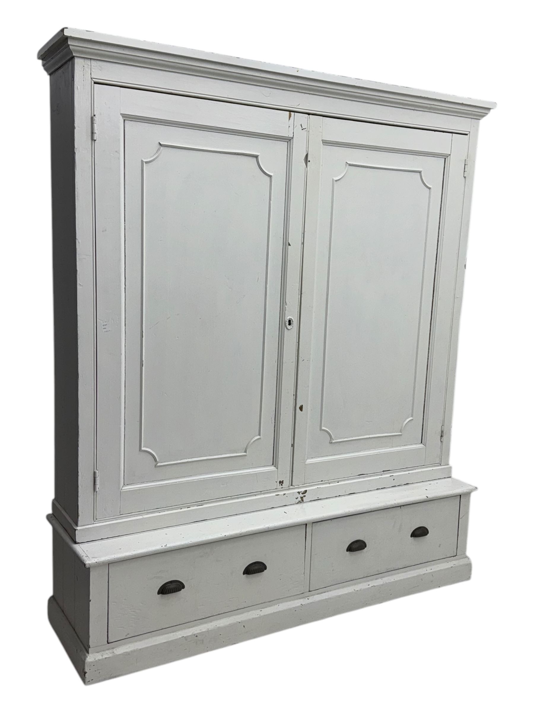 Late 19th-century painted pine housekeeper's cupboard with plinth base containing two large drawers with brass scalloped handles 