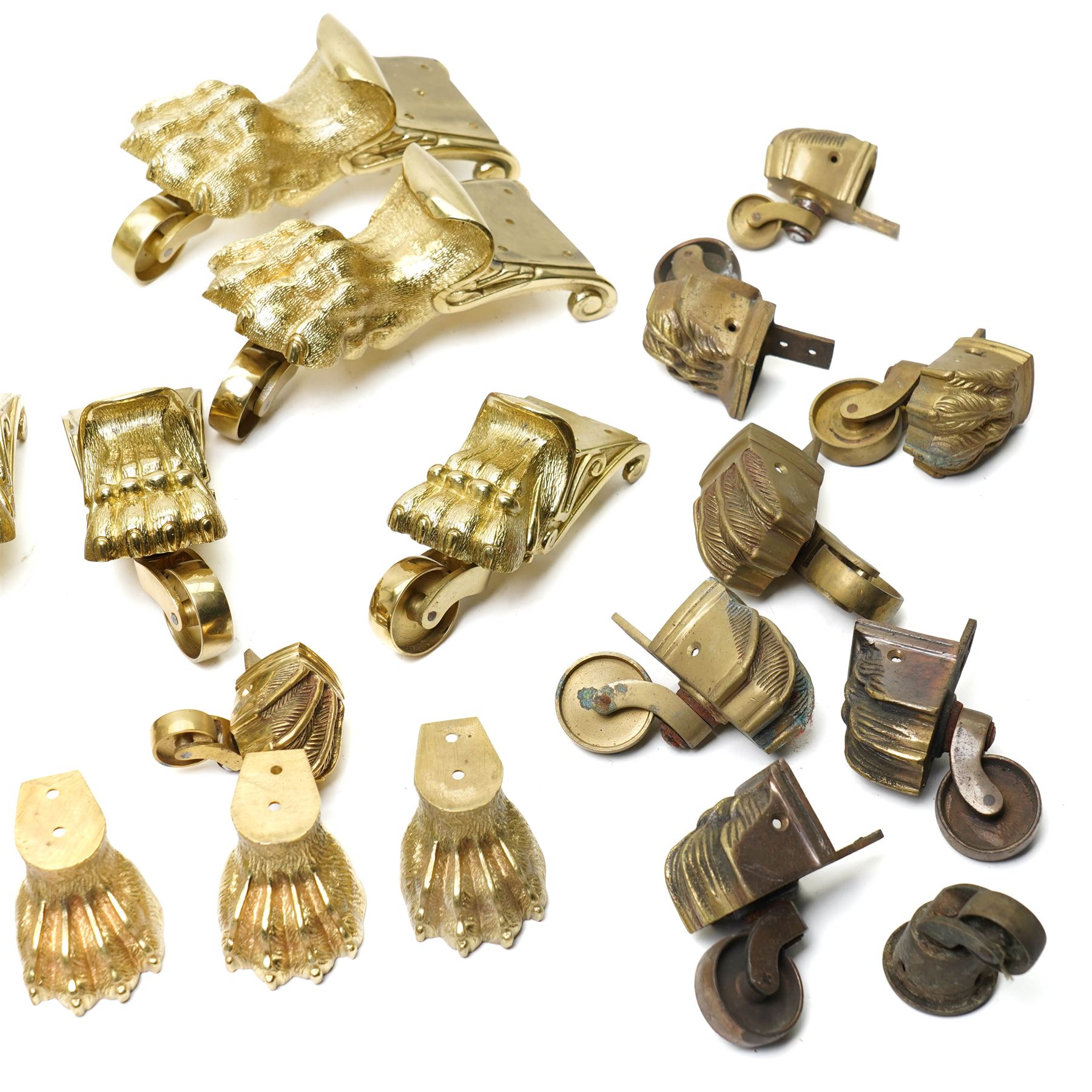 Set of four period design lacquered brass paw furniture castors by Beardmore, London, set of four matching smaller castors and a quantity of various brass castors   
Provenance: property of a Nobleman