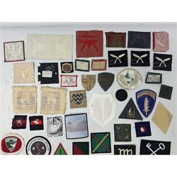 Approximately one-hundred printed and embroidered cloth badges including 3rd Indian Infantry, Chindits Hermes Wings, 6th Field Force, 1st & 2nd Army Group RA, HQ Land Forces Persian Gulf, Home Counties District, Eastern Command, Anti-Aircraft Command, 1st Anti-Aircraft Division, 51st Highland, 53rd Welsh and 4th Infantry divisions etc