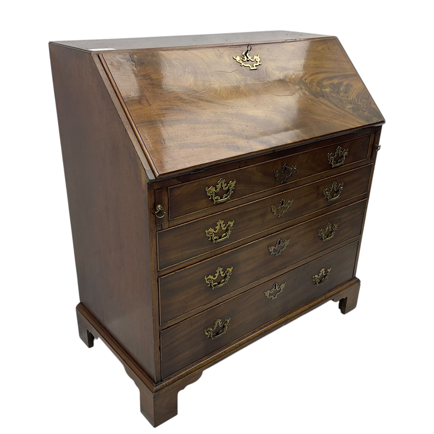 George III mahogany bureau, fall-front enclosing a fitted interior of drawers, pigeonholes and central mirrored cupboard, over four graduated cockbeaded drawers with brass batwing handles, raised on bracket feet