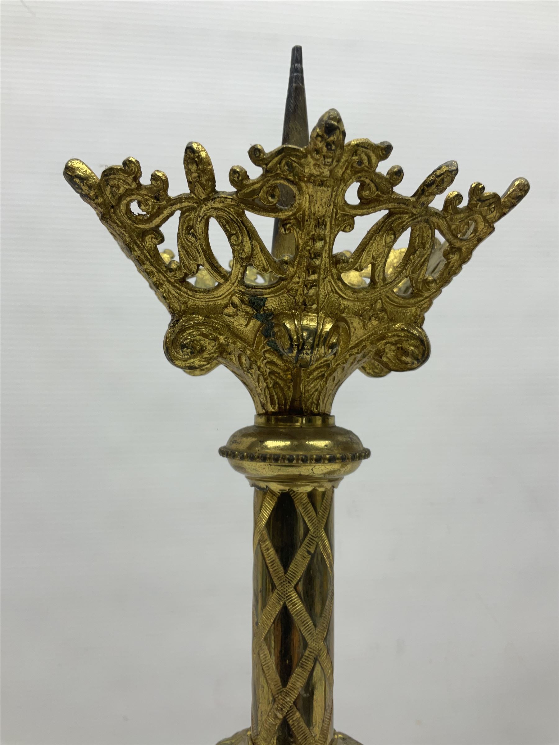 Pair of gilt metal pricket candlesticks, with applied decoration on knopt stems and triform bases, H47cm