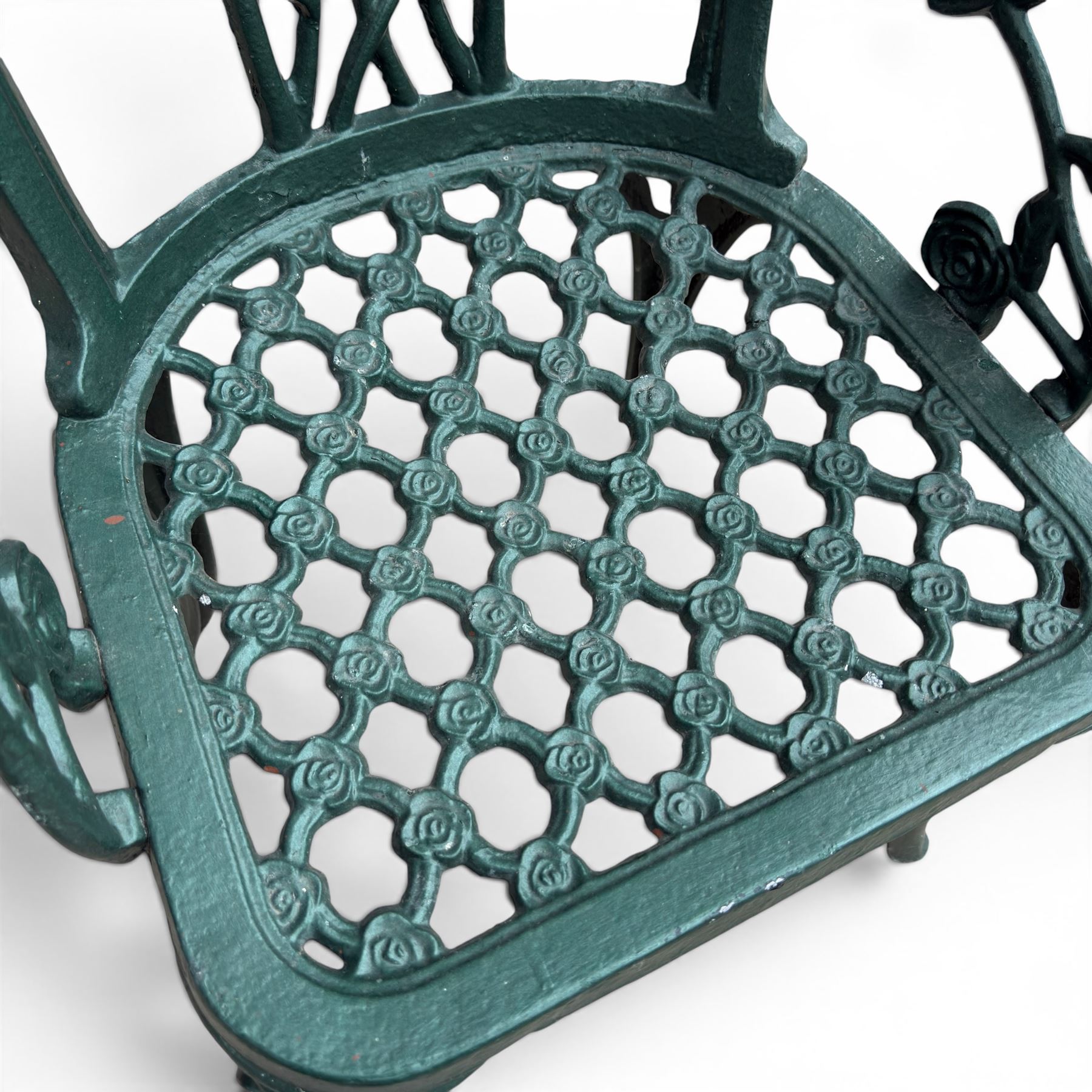 Cast aluminium oval garden table and set of four armchairs with pierced rose design back splats