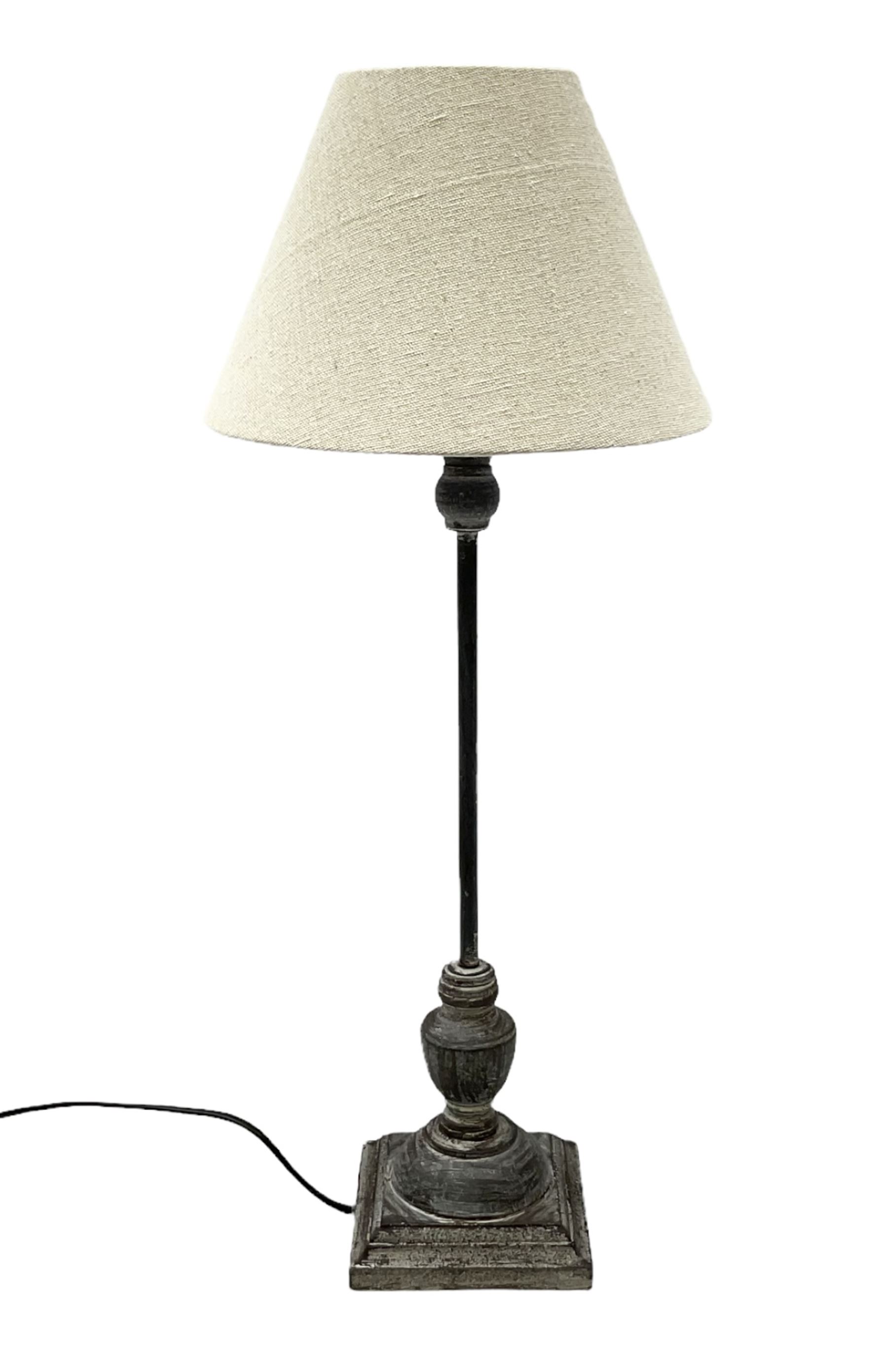 Table lamp, with a thin central stem upon a square stepped base, natural linen shade
