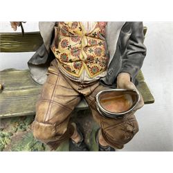 Two Capodimonte figures, comprising The Watchmaker by Curiase and Tramp Seated on a Bench, created by D.Bonalberti, tallest example H24cm