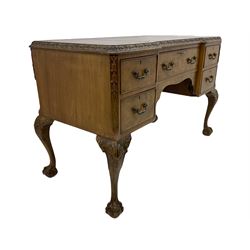Mid 20th century walnut kneehole desk, three sectional inset leather top with carved foliate mould, fitted with five drawers, on shell carved cabriole supports with ball and claw feet