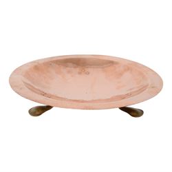 Arts and Crafts Birmingham Guild of Handicraft copper bowl, of circular form, the broad rim stamped with circles and fruiting sprigs, raised upon three cast brass feet, with impressed mark beneath The Birmingham Guild Ltd England, D30cm