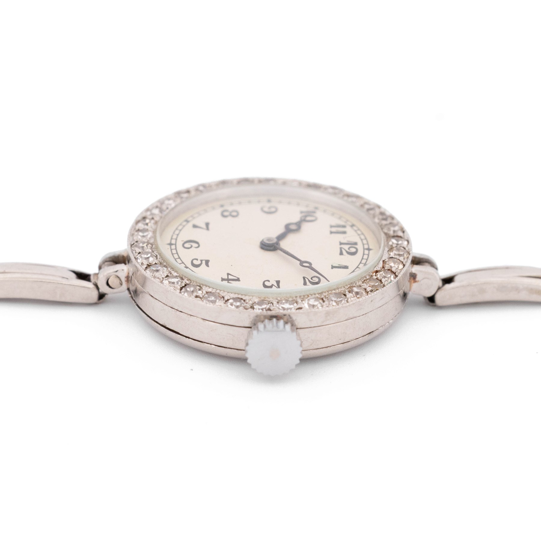 Audemars Piguet & Co Art Deco ladies platinum, diamond set manual wind wristwatch, movement No. 19931, cream / silvered dial with Arabic hour markers, the bezel milgrain set with round cut diamonds, to a platinum expanding bracelet
