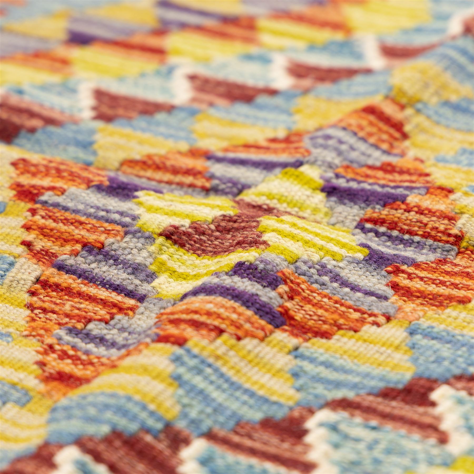 Two Chobi flatweave kilims with a repeating stepped diamond medallion design in live green, rust, teal, purple, and ivory, framed by chevron and geometric borders, 121x80cm & 87x60cm 