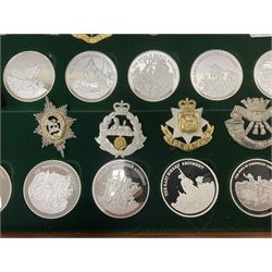 Great British Regiments, 1977, set of fifty two frosted silver medals by the Birmingham Mint, each bearing the name of a regiment with a depiction of an action on the obverse and further details on the reverse, all hallmarked Birmingham Mint, assay offices and dates; together with 52 base metal copy cap badges for each regiment, all housed and mounted on two trays and contained within a wooden presentation case, with brass plaque and fittings, lock and key, with a certificate of authenticity 