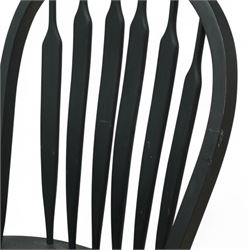 Contemporary country style pine and painted dining table and four chairs, the rectangular plank top with exposed knots and pegged detailing over black painted turned legs, the four Windsor style chairs with shaped seats, spindle splats and turned stretchers, also painted black