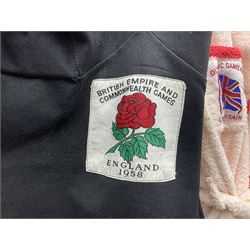 On the direct instructions of Anita Porter nee Lonsbrough Great British Olympic and Commonwealth Games gold medal winning swimmer - collection of early and international memorabilia comprising original Huddersfield Bath Club track suit top bearing eight stitched on cloth badges including British Empire & Commonwealth Games 1958 England Team, YSASA, North Eastern Counties ASA, ESSA Division 3,  English Schools Swimming Association winner etc
The swimming costume Anita wore at the 1958 Commonwealth Games in Cardiff, her first major championships, where she won two gold medals. The grey elastic on the sides, in those days, she would use to make it tighter and more streamlined.
Blue track suit from the 1960 Olympics which she wore on the podium receiving the gold medal.
1960 pool side towelling robe used at the Rome Olympics (interesting to note her name is spelt wrong on the embroidered label).
1962 Commonwealth Games pool side towelling robe used in Perth Australia when winning three Gold medals. 
It was also this year she became BBC Sports Personality of the year, the first female to do so.
Her 'lucky' pool side towel which she took with her to every event she competed in and which can be seen round her neck in many official celebratory photographs. Copies of some of these photographs are included for identification.
In addition there are two souvenir programmes of an evening event to honour Anita at The Theatre Royal Huddersfield and she has kindly signed the front cover on one of these.