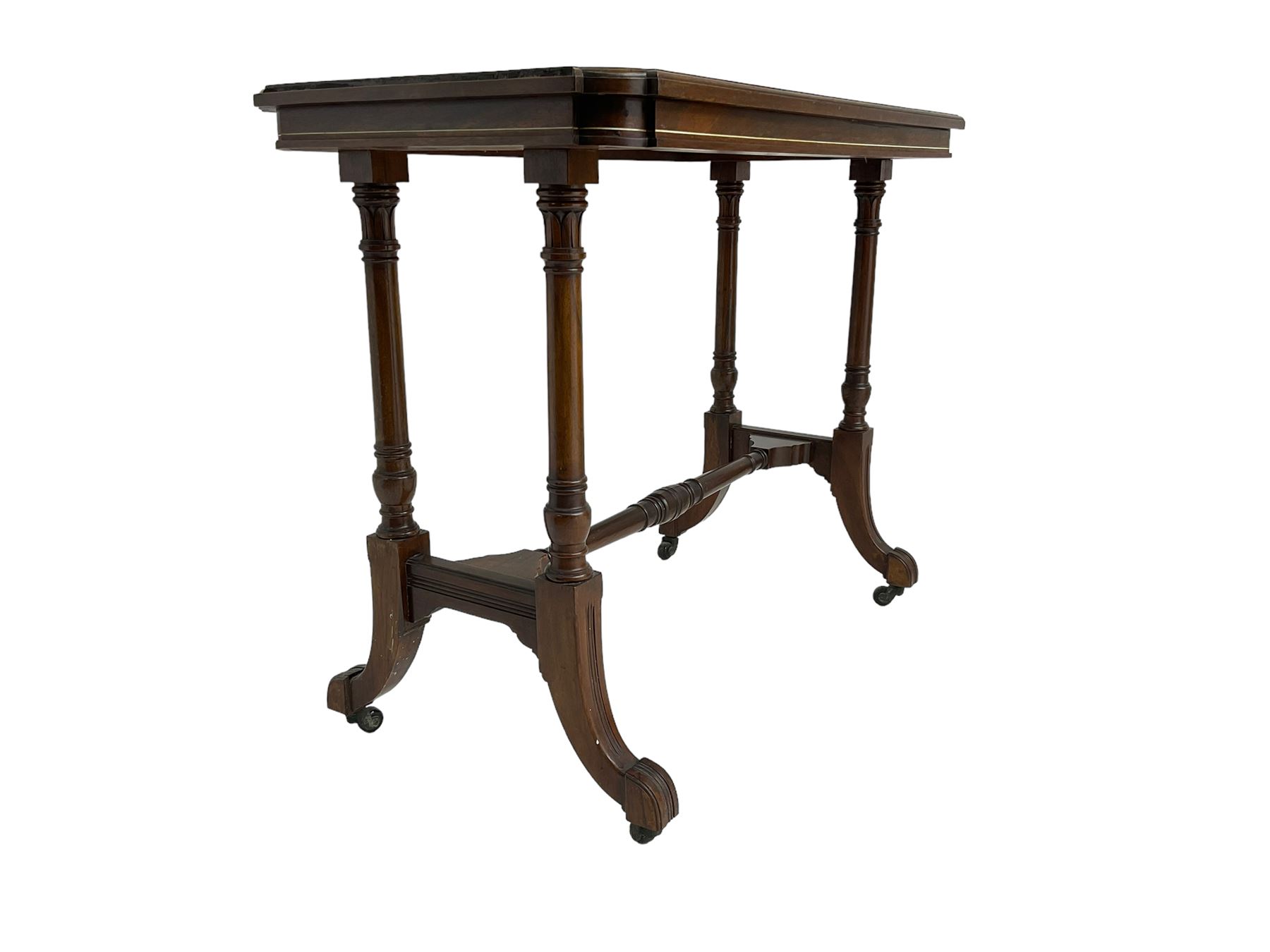 Late Victorian rosewood stretcher table, the rectangular top with curved canted cornice and moulded edge, on quadruple turned pillar supports carved with foliage, joined by collar turned stretcher, on splayed moulded supports with brass and ceramic castors