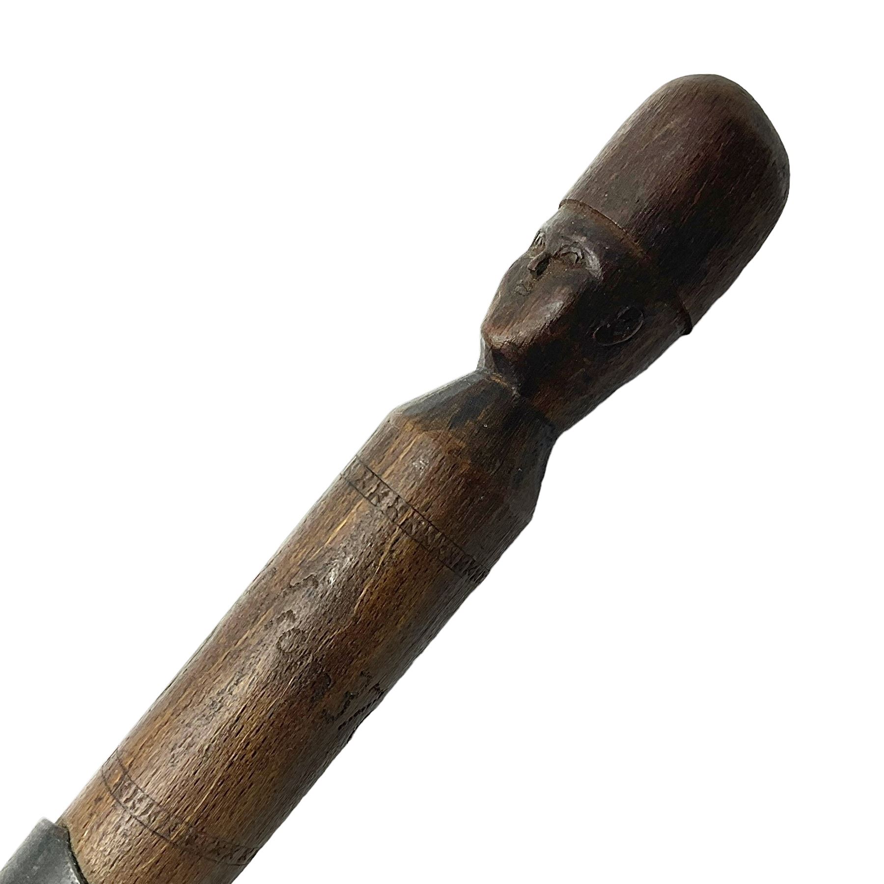 WW1 Prisoner of War carved beech walking cane, the terminal as a head wearing a helmet, and inscribed 'Souvenir from 370th PoW Coy Menin 1919'; bears metal plaque with indistinct monogram L91cm