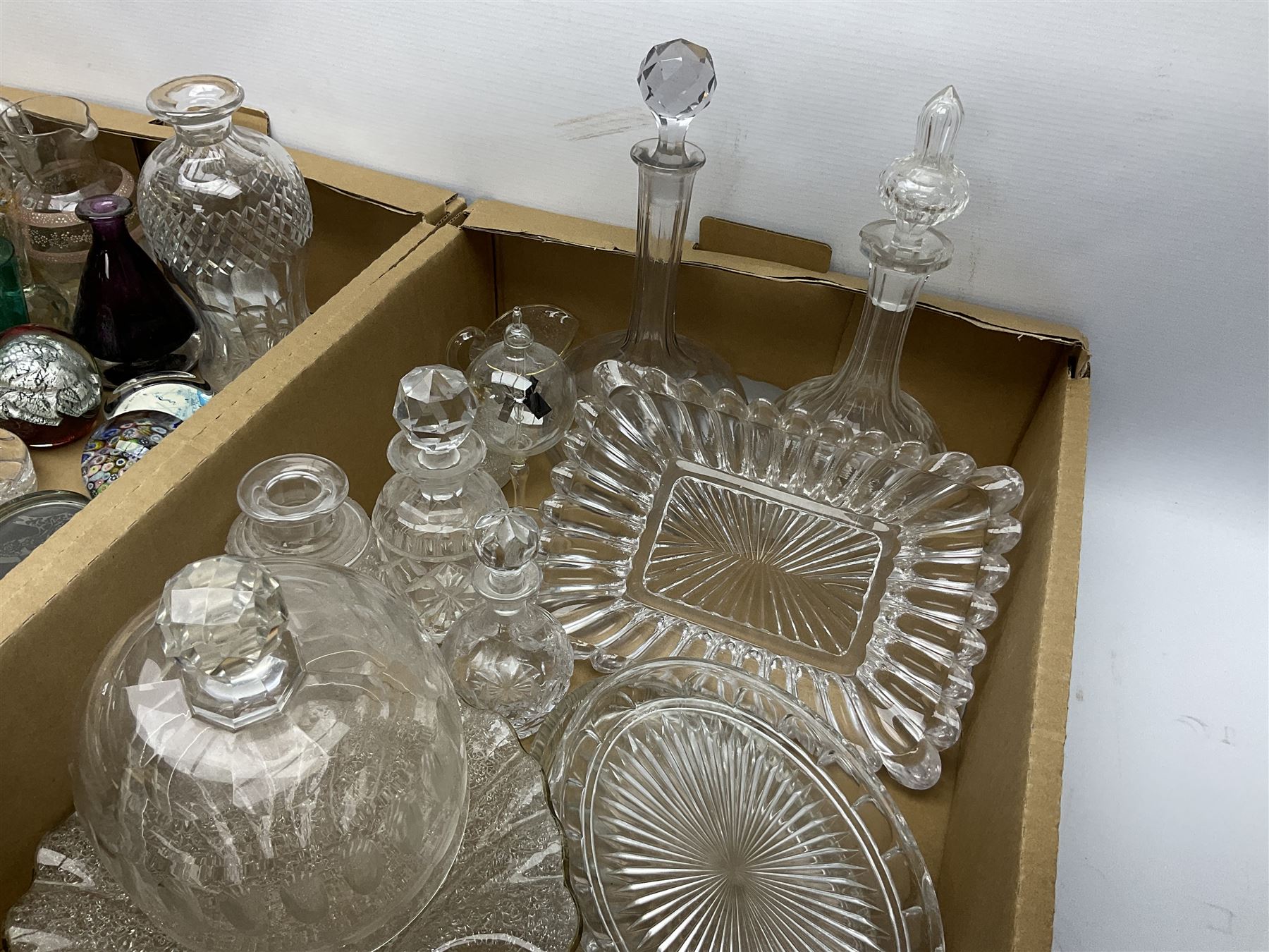 Millefiori paperweight, together with Caithness paperweight, Isle of Wight vase, cranberry glass tumblers, claret jug, decanters and other glassware, in three boxes 