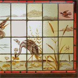 Large Victorian Aesthetic movement stained glass leadlight window panel, hand painted with a scene of herons and other birds in a lake, overall 82cm x 147cm 