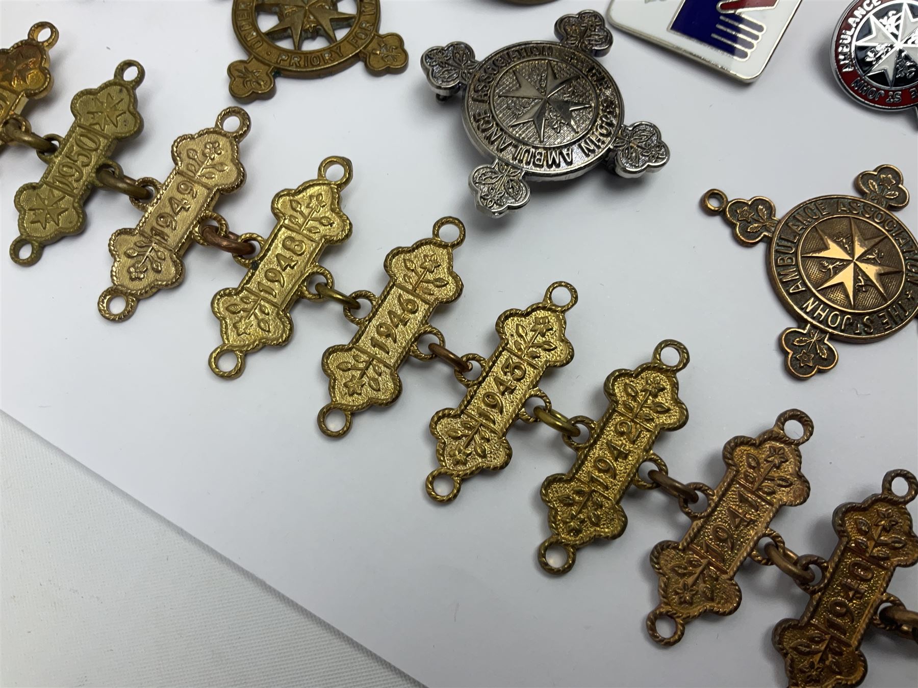 Collection of St John Ambulance enamel and metal badges, together with Red Cross medals and badges