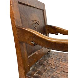 Mouseman - circa. 1930s set of six (4+2) oak dining chairs, panelled back carved with the Bagshawe family crest, the moto 'Forma Flos Fama Flatus' over an arm grasping a bugle-horn with ribbon tie and Yorkshire rose motif, adzed frame, leather lattice strap seat, on octagonal supports united by stretchers, two carvers and four side chairs, each carved with mouse signature, by Robert Thompson of Kilburn 

Provenance: Owned since manufacture by the Bagshawe family, descendants of the Staithes Group Artist Joseph Richard Bagshawe RBA (1870-1909).