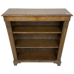 Georgian design walnut open bookcase, fluted uprights with acanthus carved capitals enclosing two adjustable shelves, on bracket feet