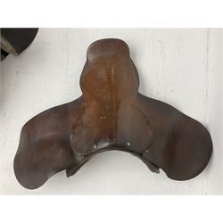 Collection of nine saddles, mainly havana leather to include a racing saddle and a Goodwin saddle, some with stirrups and leathers 