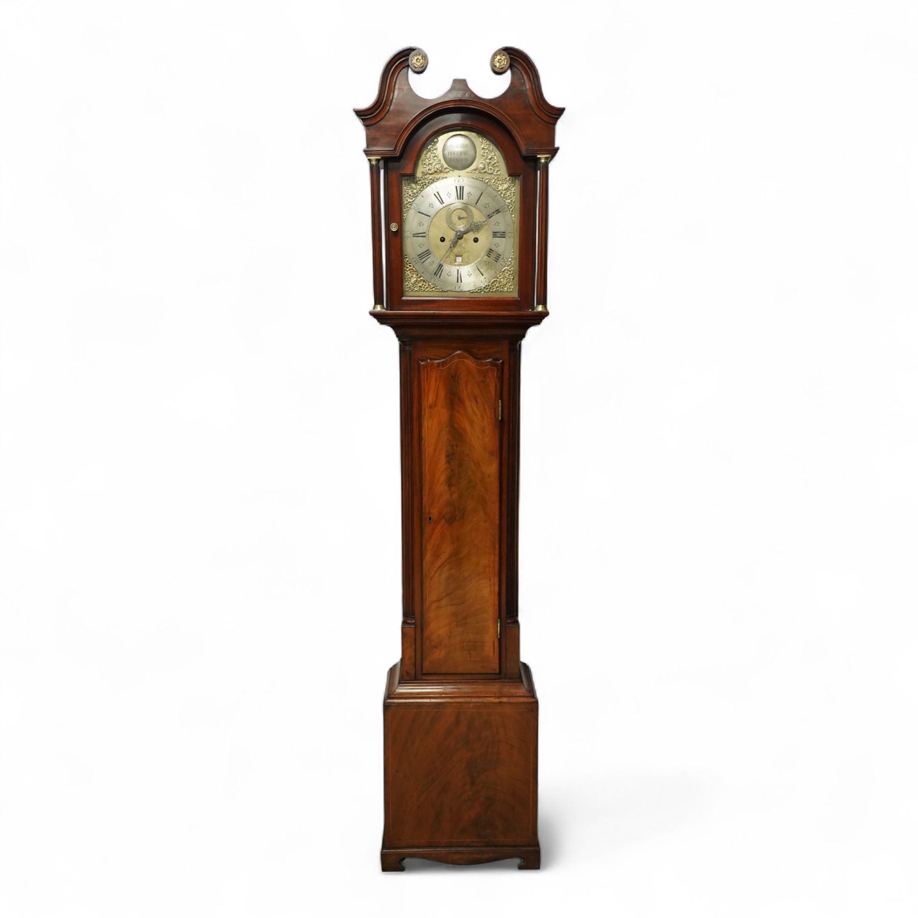 Samuell Hollyar of London - mid-18th century, figured mahogany Longcase clock with a swan neck pediment and brass parterre, with glass panels to the sides and reeded pilaster flanking the hood door, conforming recessed pillars to the trunk and a wavy toped door with  inlay, square plinth raised on bracket feet, With a brass dial with cast spandrels and makers name to the arch, matted dial centre with steel hands, seconds dial and date aperture, silvered chapter with Roman numerals, five minute Arabic's, minute and inner quarter hour tracks, dial pinned to an 8-day rack striking movement, sounding the hours on a bell. With weights and pendulum.
Samuel Hollyar is recorded as being apprenticed in London in 1683 and a member of the clockmakers company 1705-20.