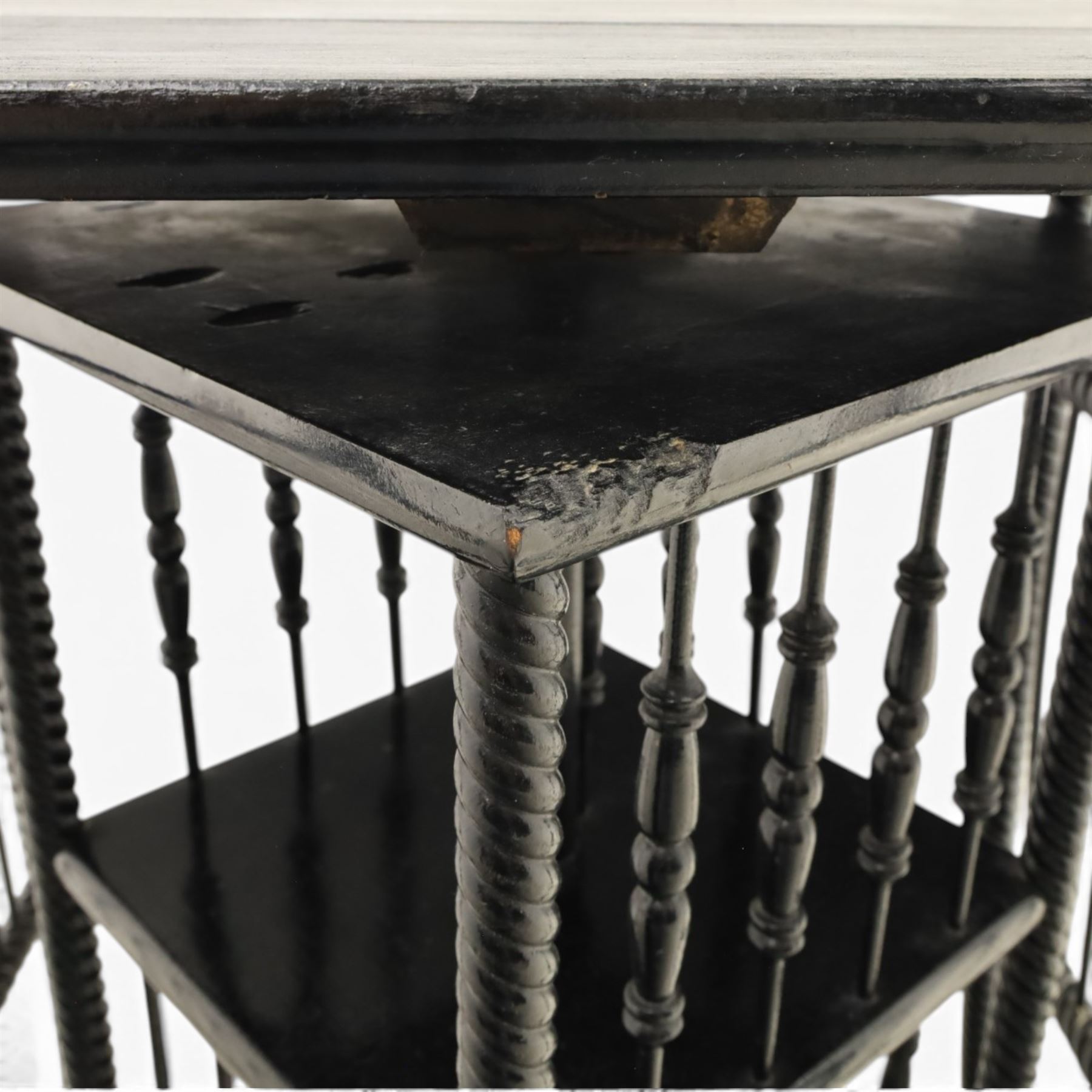 Edwardian black painted side table with incorporated revolving bookcase, supported on barley twist legs