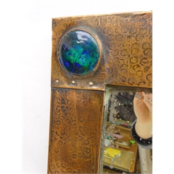  Arts & Crafts rectangular wall mirror with planished copper frame, inset with four blue and turquoise Ruskin cabochons and riveted borders, probably retailed by Liberty of London 63.5cm x 53cm  