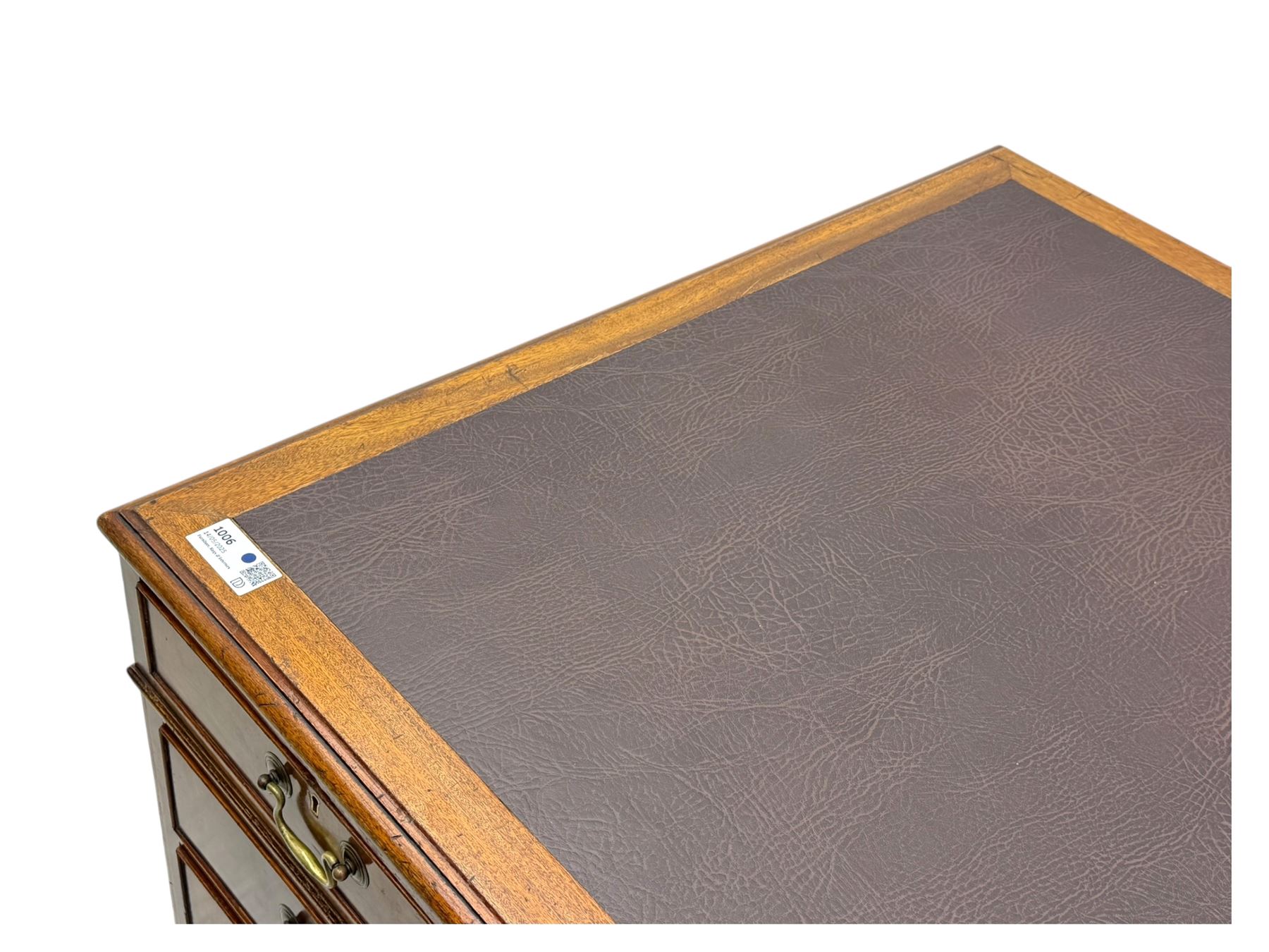 Edwardian mahogany twin pedestal desk, rectangular burgundy leather top moulded edge, over three short drawers with brass swan neck handles, over twin pedestals with graduating drawers supported on bracket feet