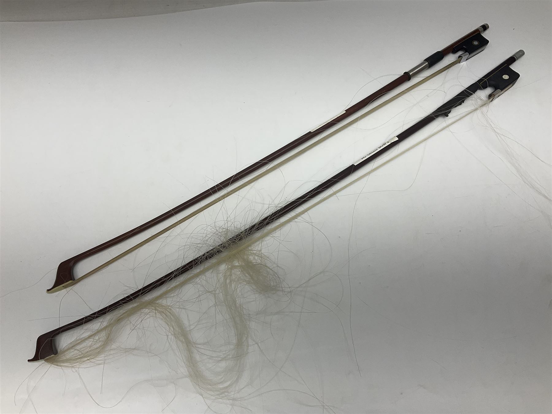 Two student half-size cellos - Boosey & Hawkes Artia with 65cm one-piece back and spruce top; bears maker's label; L104cm overall; and Romanian with 65.5cm two-piece maple back and ribs and spruce top; bears label; L108.5cm overall; each in soft carrying case with two bows (2)