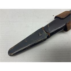 Third Pattern Commando Knife or Dagger with 17.5cm flattened diamond section blade and regulation black painted ribbed copper hilt with brass pommel nut; stamped William Rodgers Sheffield England to the cross-piece; in black painted brass mounted leather scabbard L34.5cm overall