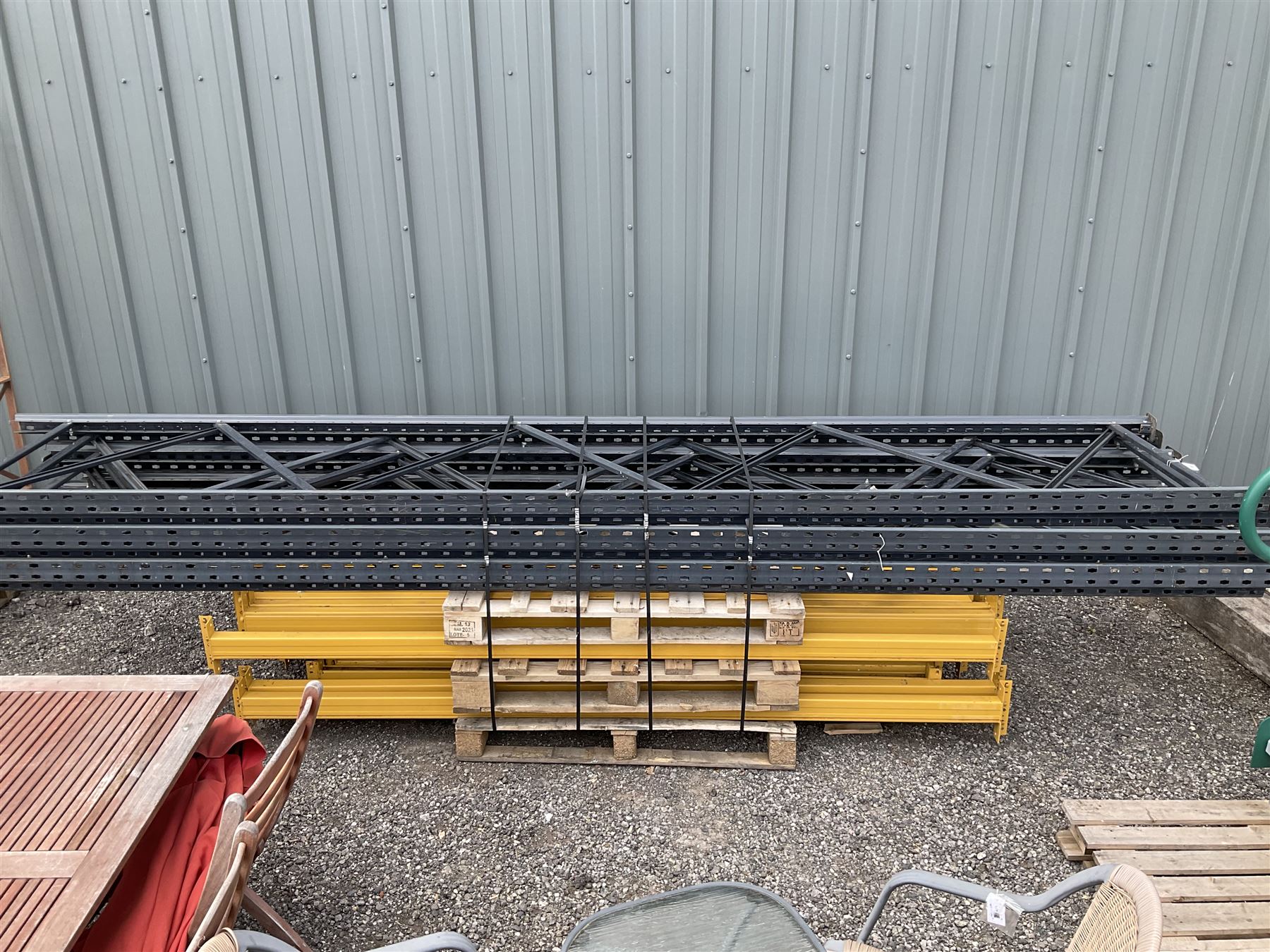 Steel industrial pallet racking with uprights (6), and beams (24) with