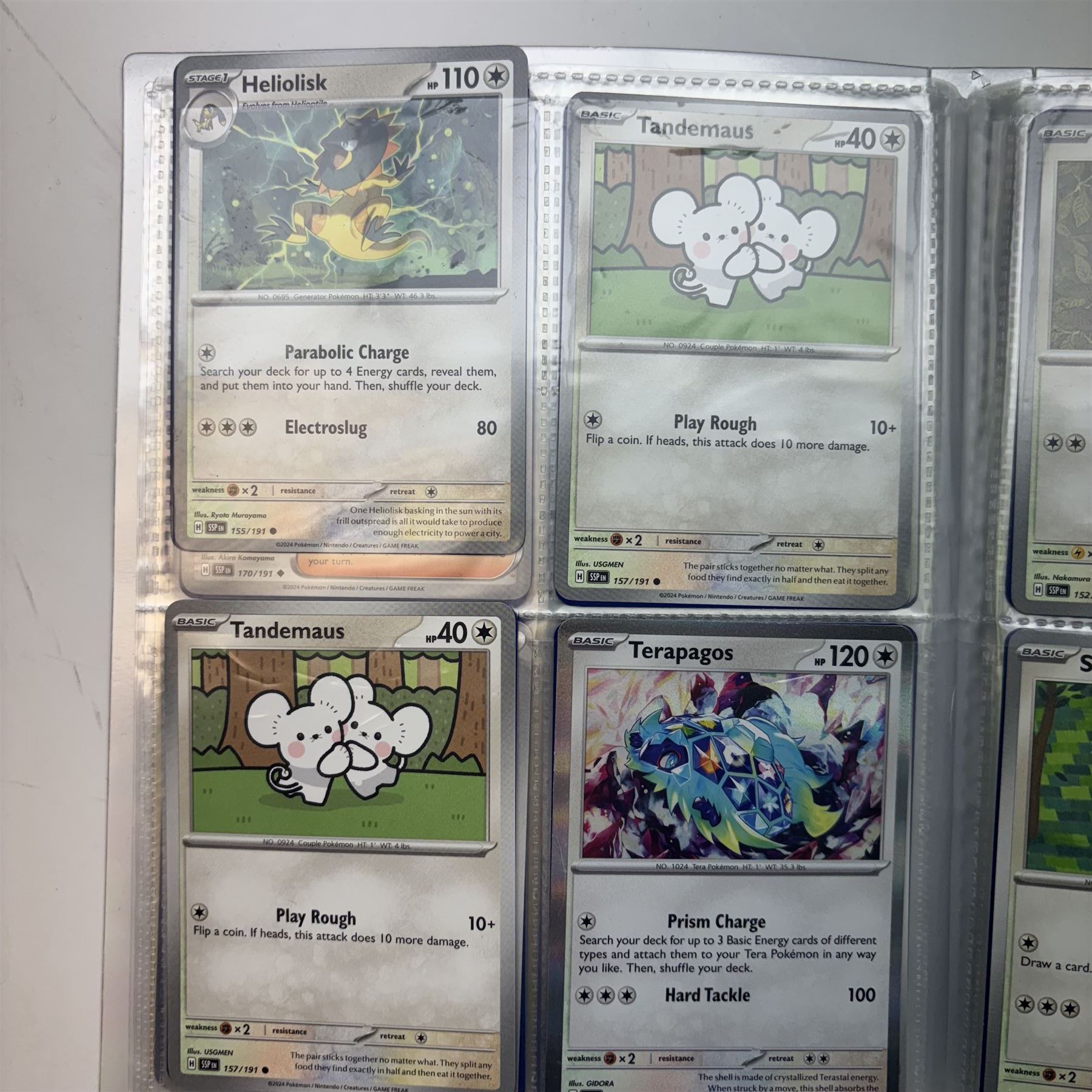 Collection of modern Pokemon TCG trading cards from the Scarlet & Violet and Sword & Shield eras, contained within in two folders, opened packets and loose, together with a graded Sword & Shield Silver Tempest Passiman TG08, GET Graded 9 Mint, two oversized cards, energy cards, vintage booklets and boxes, empty tins, 1998 Electronic Pokédex and other accessories