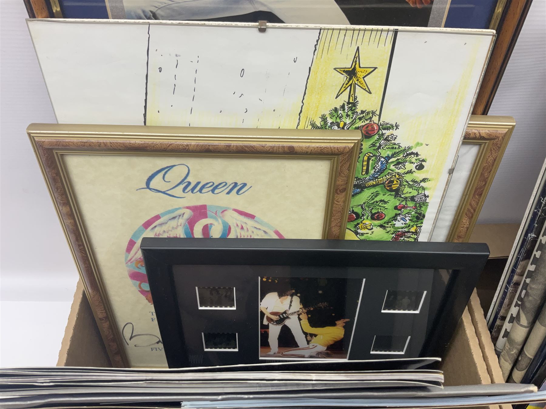 Mostly Queen and Freddie Mercury interest items, including pin badges, newspaper cuttings, diecast 'promotional' vehicles, special edition Pop Rocks figure of Freddie Mercury, VHS tapes, two charity certificates signed by Brian May and Roger Taylor, poster etc, in two boxes 