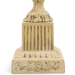 Table lamp modelled as a twin handled urn, decorated in relief with floral sprigs, upon a stepped rectangular base, with a cram lampshade, H53cm, without lampshade 