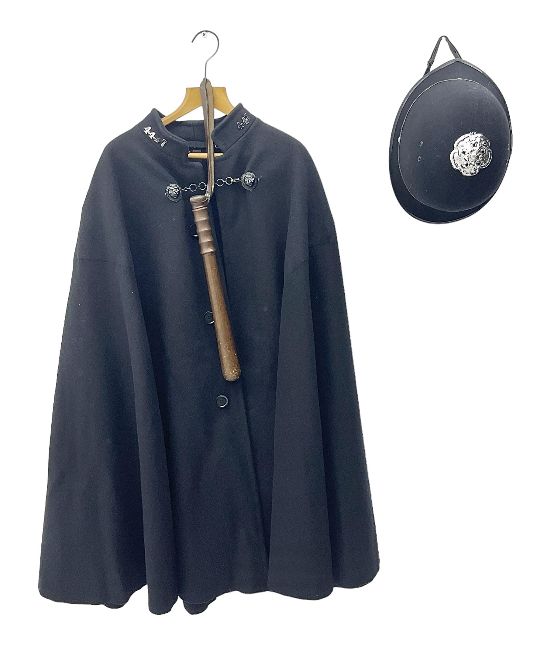 Police Constabulary style uniform items comprising woollen night cape / cloak with chain fastening, helmet and truncheon