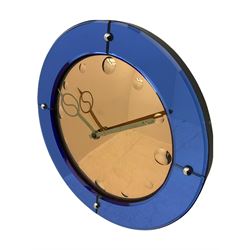 A Smiths 'Venus' Art deco electric wall clock with a convex peach and cobalt mirror dial, with etched circular numerals and silver painted hands, hour hand incorporating a stylised 'S' design, original Smiths 'SEC' mains operated self-starting motor. 15'' diameter. Movement untested.


