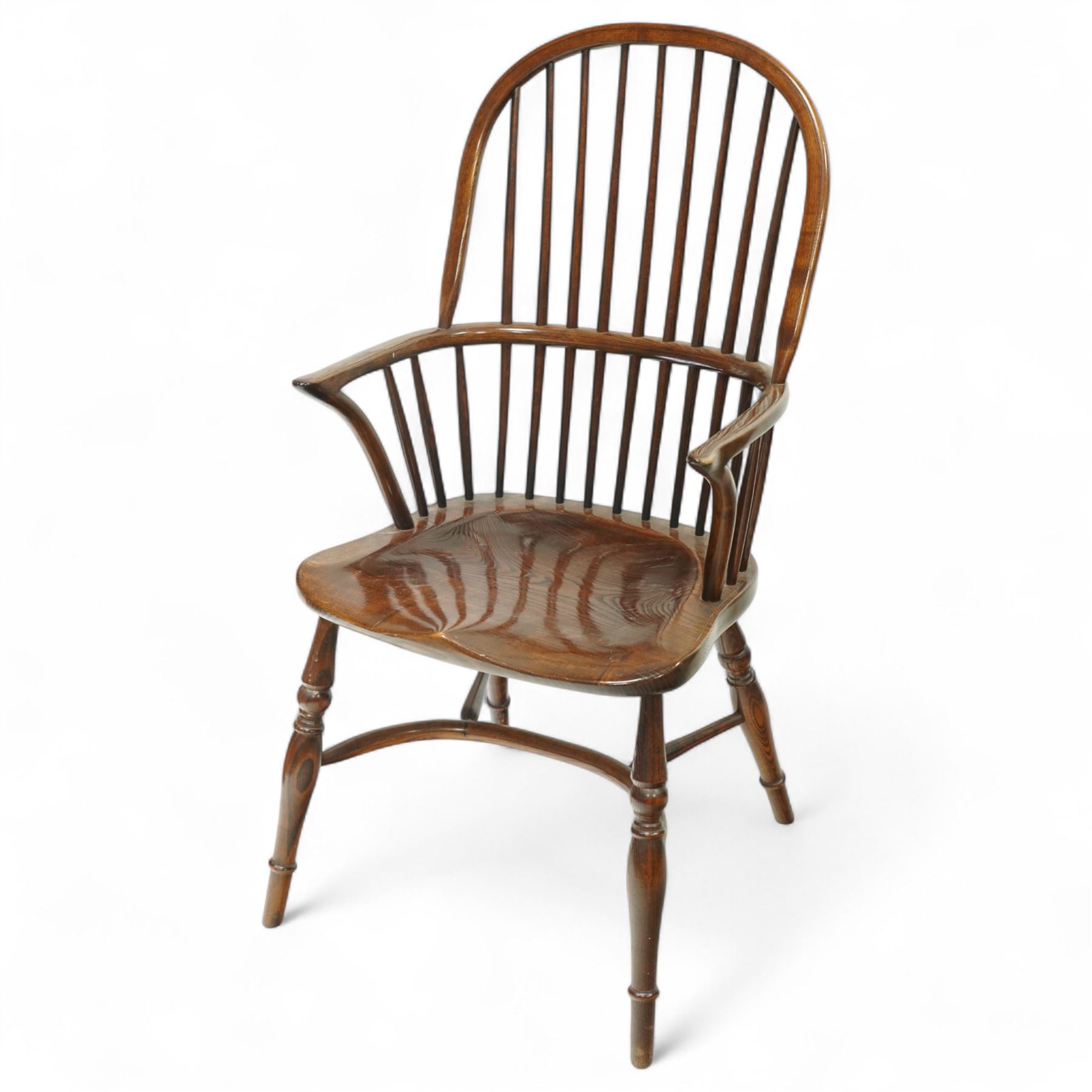 Late 19th century ash and elm Windsor armchair, with hooped back and spindle supports, shaped elm saddle seat, on turned legs united by crinoline stretcher