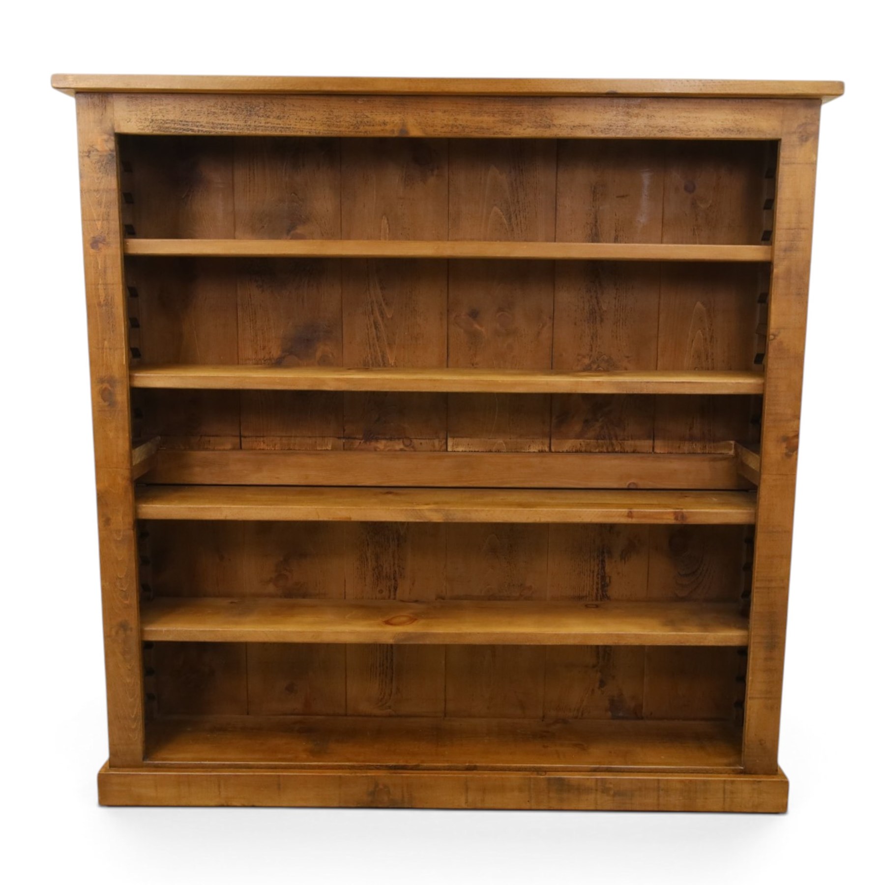 Indigo Furniture - large rustic oak open bookcase, with four adjustable shelves, above a plinth base 