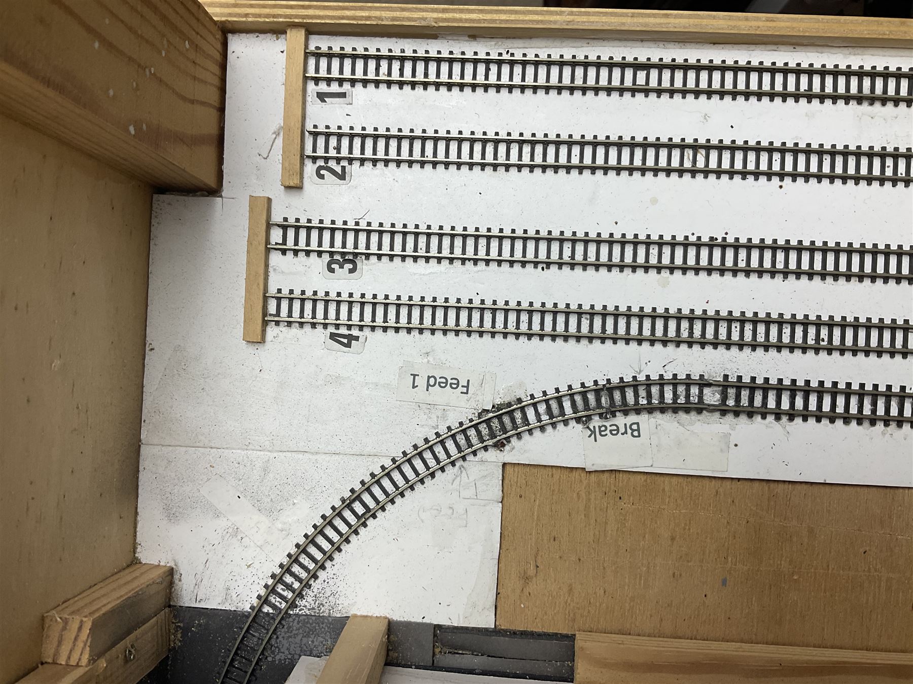 'Z' gauge continental scenic layout with folding legs, various loops of track and sidings with overhead cables, buildings including water tower, tunnels, roads with motor vehicles and figures, trees, haven with boats, backdrop diving wall hiding control units 150 x 50cm