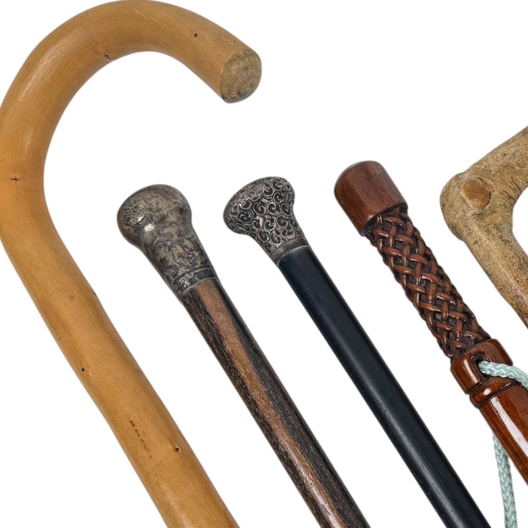 Collection of walking sticks, including two silver topped examples, hallmarked