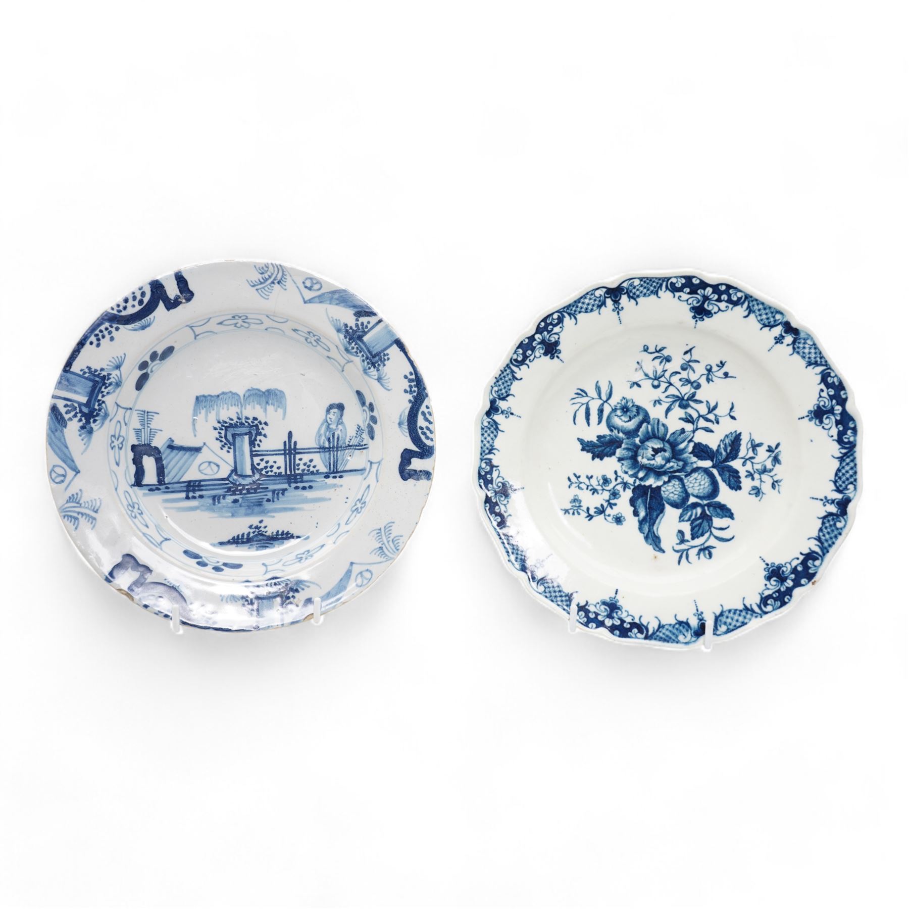 First Period Worcester plate, decorated in the Pine Cone pattern, cresent mark beneath D22.5cm, together with an 18th century Delft plate, painted with a Chinese figure by a fence, D23cm (2)