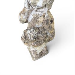 Early composition stone figure of a boy with grape basket, original flakey white paint