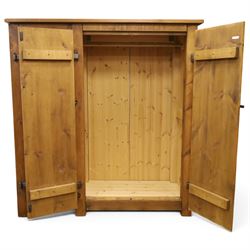 Indigo Furniture - rustic oak triple wardrobe, fitted with three doors with wrought metal fittings and locks, on style supports