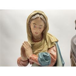 Two religious painted plaster figures of Mary and Joseph kneeling on oval plinths, with impressed mark 'Raffl et Cie Paris', H60cm 