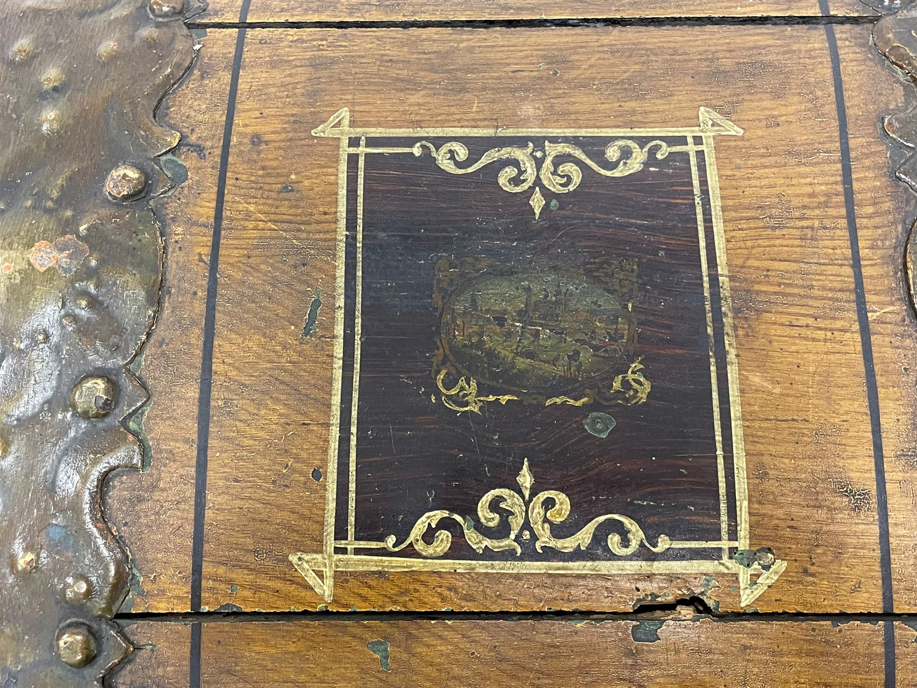 19th century painted oak sea chest, hinged dome top enclosing small compartment, bound by shaped and pressed metal strapwork, scumbled finish to resemble oak and painted with small vignettes depicting portraits and landscapes within panels, fitted with large wrought metal carrying handles, the front inscribed 'H.J.S. 1870' 