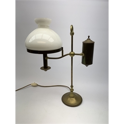 A brass students lamp, with adjustable arm supporting counter weight and white glass shade, H49cm. 