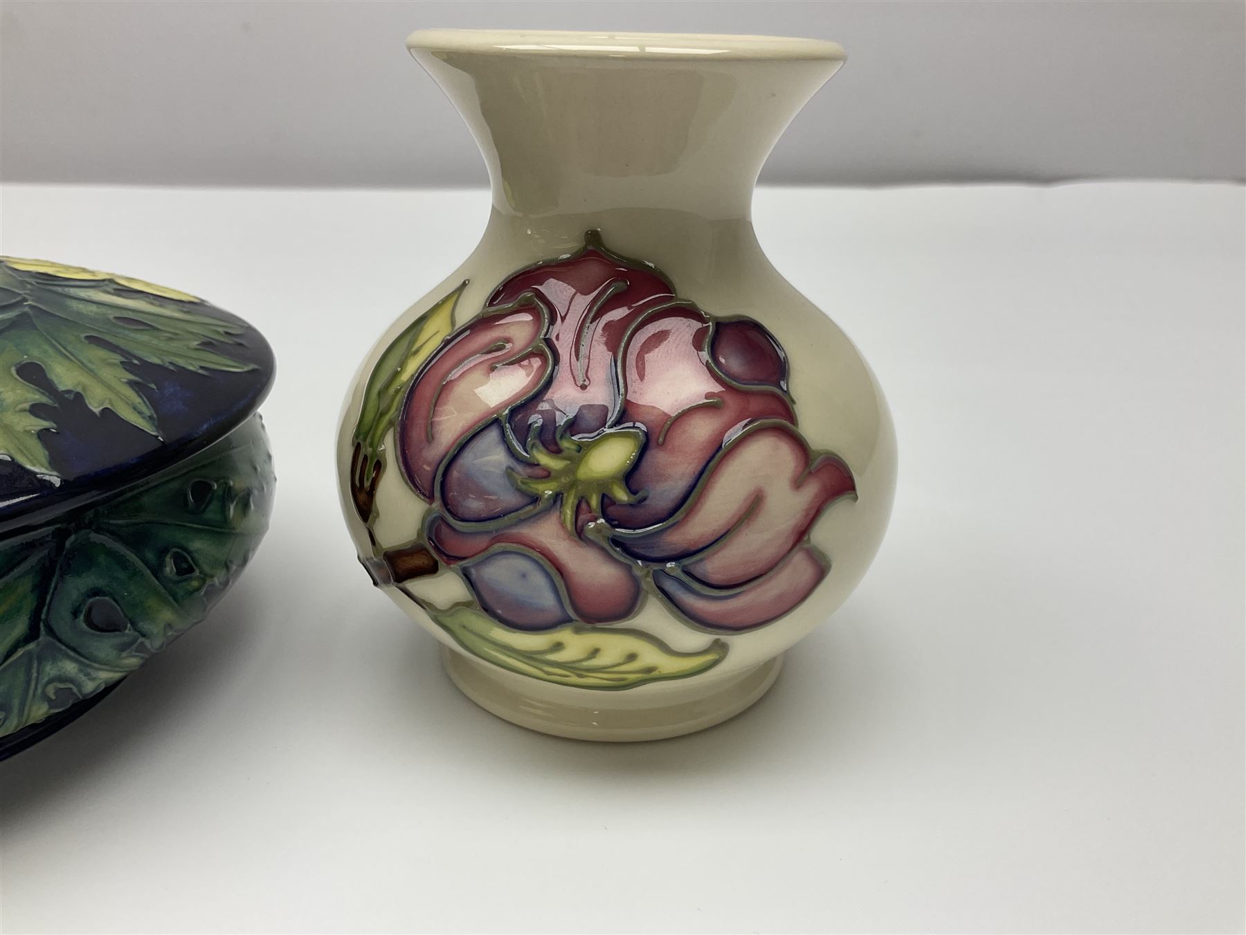 Moorcroft dish and cover, of circular form, decorated in Buttercup pattern, together with a Moorcroft vase, of baluster form, decorated in Magnolia pattern, both with printed marks beneath, tallest H9.5cm