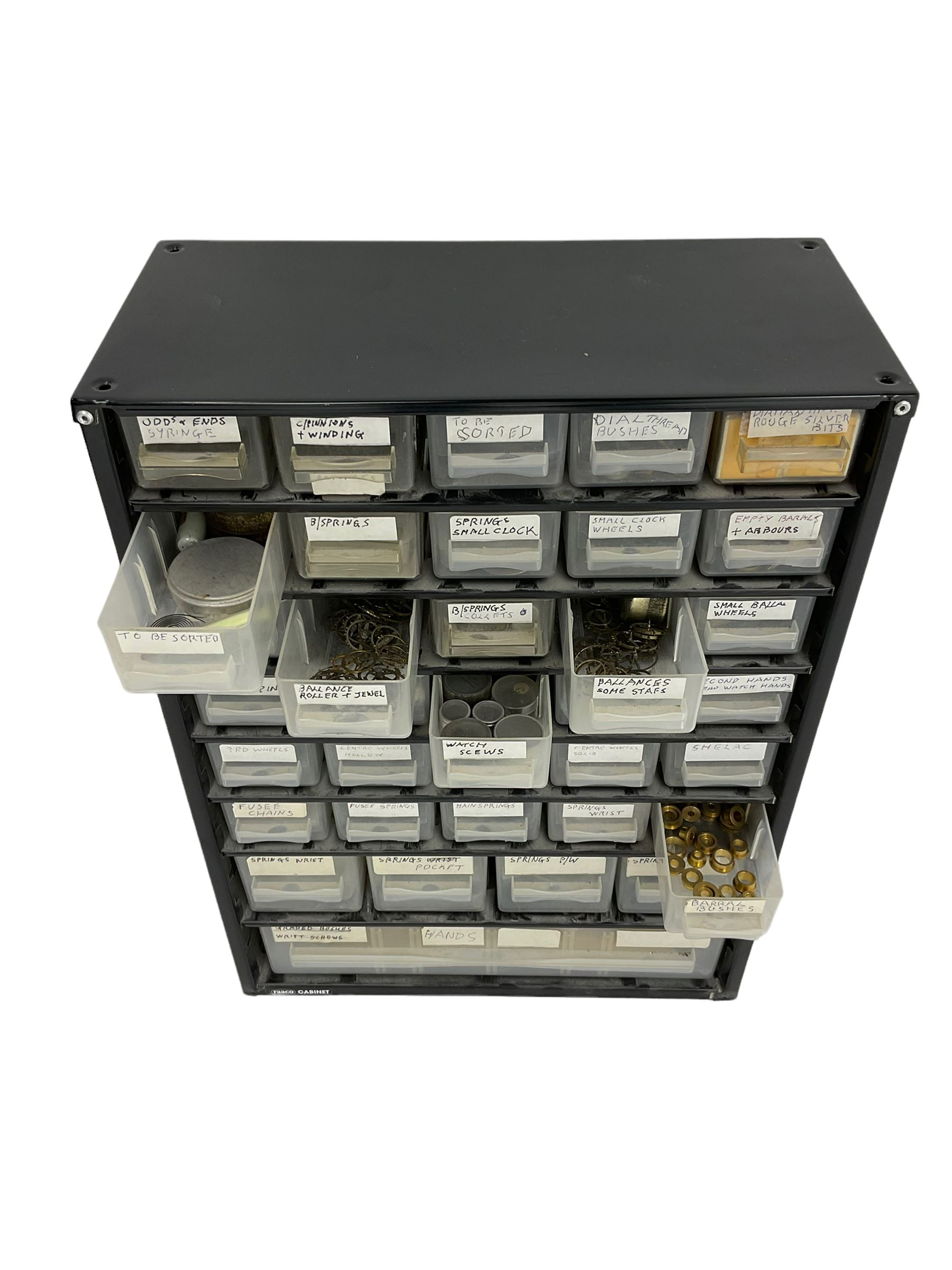 35 draw container of miscellaneous watch and clock parts including watch screws, balance wheels, barrel bushes, pocket watch springs, pocket and wrist watch mainsprings, fusee chains, and long case hands.